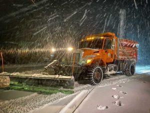 Dump truck plowing road